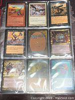 Shows nine Magic The Gathering cards in plastic sleeves with a variety of creatures and spells visible.