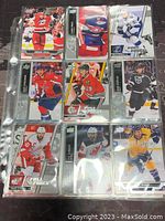 Front side of 9 NHL player trading cards showing various players in team jerseys in action poses or portrait style.