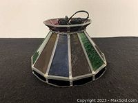 Side view of the stained glass ceiling light showing multicolored textured glass panels and metal framing.