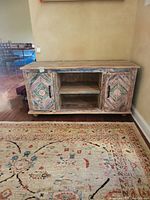 Full front view of console showing two painted cabinet doors and central open shelving.