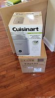 Photo showing boxed Cuisinart ice cream maker on top of boxed Instant Pot pressure cooker, both unopened.