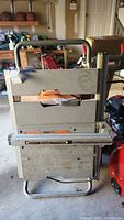Front view of the Ridgid TS2400-1 table saw mounted on folding cart in garage setting