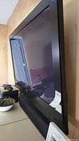 Side view of a large black 50-inch flat screen TV showing size and frame.