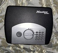 Front view of the digital keypad safe showing keypad, dial, and Master Lock branding.