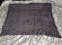 Gray plush throw blanket laid flat showing square stitched pattern and the overall size.