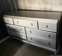 Front angle view of entire dresser showing silver finish and drawer layout