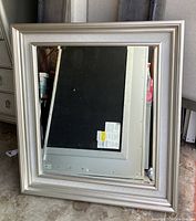 Front view of square silver-framed beveled mirror