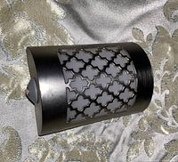 Stainless steel night light showing side profile with sensor/button visible on the curved top edge.