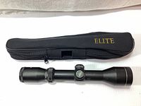 Excalibur Twilight DLX crossbow scope laid next to the Elite carrying case showing full length and condition.
