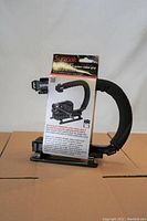 Full view of the Sunpak Action Video Grip in packaging, showing the product and included information about its use and features.