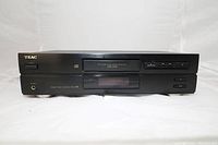 Front view of the TEAC CD-P3100 CD player showing disc tray, buttons, and display screen.