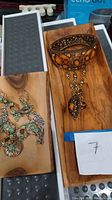 Wooden tray with pair of green stone and metal accent earrings