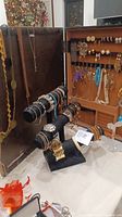Two-tier black T-bar stand displaying assorted bracelets