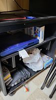 Shelf with Memorex DVD player, Nintendo 64 console, controllers, and other items