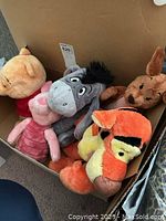 Box with six Winnie the Pooh character plush toys showing Pooh, Piglet, Eeyore, Roo, Tigger