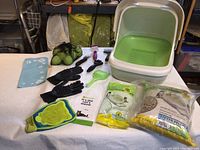 Photo showing the complete assortment of cat care items including litter box, brushes, tennis balls, scoop, grooming gloves and cloth.