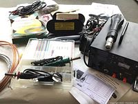 Full view of the soldering supplies including the soldering station, soldering irons, cold heat tool, wires, and accessories.