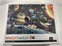 Front of sealed 1000 piece jigsaw puzzle box featuring space traveler theme with planets, astronauts, and spacecraft.