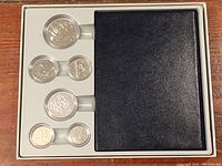 Complete 1987 Canadian proof coin set in black and white case with six coins in protective capsules arranged in foam insert.