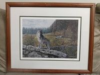 Full image of the framed print showing wolf on rock with forest background