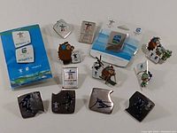 Photo showing 14 Vancouver 2010 Winter Olympics pins including mascot pins, sport-themed pins, and branded BC Hydro pins.