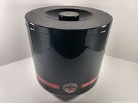Front and side view of the black Bacardi ice bucket with Bacardi logo on exterior.
