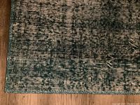 Close-up of rug corner showing woven pattern and edge binding