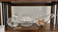 All three glass pieces displayed side by side on wooden shelf.