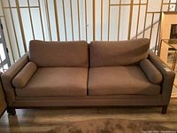 Front view of entire sofa showing silhouette, cushions and bolsters