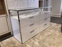 Angled view showing full dresser, chrome frame, drawers, glass top and marble base