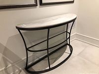 Full front view of half-moon console table against wall