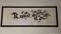 Full frontal view of entire framed artwork, showing composition of galloping horses and matting.