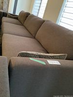 Angled view of full sofa showing three-seat cushions and straight arms