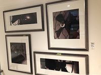 Overview of all four framed prints installed on wall