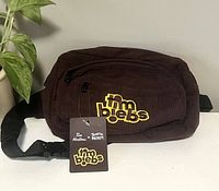 Brown Timbiebs branded fanny pack with front and main zippered compartments, adjustable strap, and Tim Hortons x Justin Bieber tag