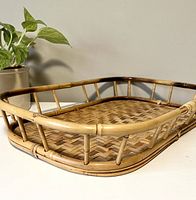 Side angled view showing woven bamboo base and low raised bamboo rails around the edge