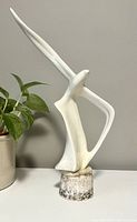 Front perspective of the white ceramic seagull statue showing wing details and base.