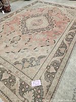 Overall view of carpet showing full medallion design and border