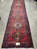 Full-length view of runner rug showing overall multi-medallion pattern and borders