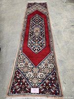 Full view of red and beige runner showing central medallion and borders