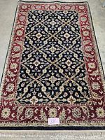 Full view of rug showing overall design, colors, condition and fringe
