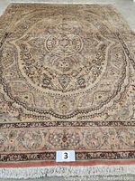 Full view of carpet showing overall medallion design and border