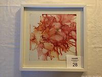 Framed abstract alcohol ink painting on Yupo paper with red and pink hues, signed by artist Gabriele Craig.