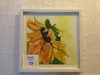 Framed original alcohol ink painting depicting a bending sunflower with vibrant colors signed by Gabriele Craig.