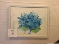 Framed original alcohol ink painting on Yupo paper featuring blue abstract floral shapes with green accents signed by Gabriele Craig.