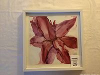 Framed original alcohol ink artwork depicting a burgundy blossom with abstract petals in various shades of red and purple, signed by artist.