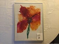 Frontal photo of the framed original painting showing the abstract flower in red, orange, and green colors. White background with silver frame visible.