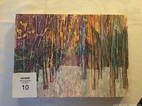 Original watercolour and mixed medium painting on mylar mounted on board, signed by Gabriele Craig, depicting a winter forest scene with melting snow in late daylight, measuring roughly 12x15 inches.