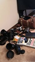 Overhead view of entire lot showing cameras, lenses, bag, book and accessories
