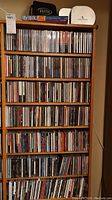 Full-height wooden CD rack filled with approximately 350 CDs
